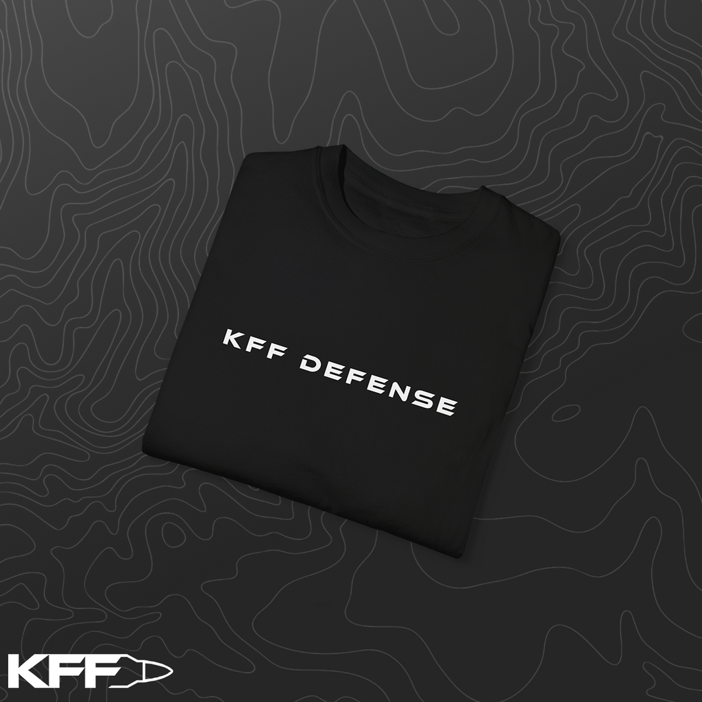 Folded black t-shirt with 'KFF Defense' text on a dark background